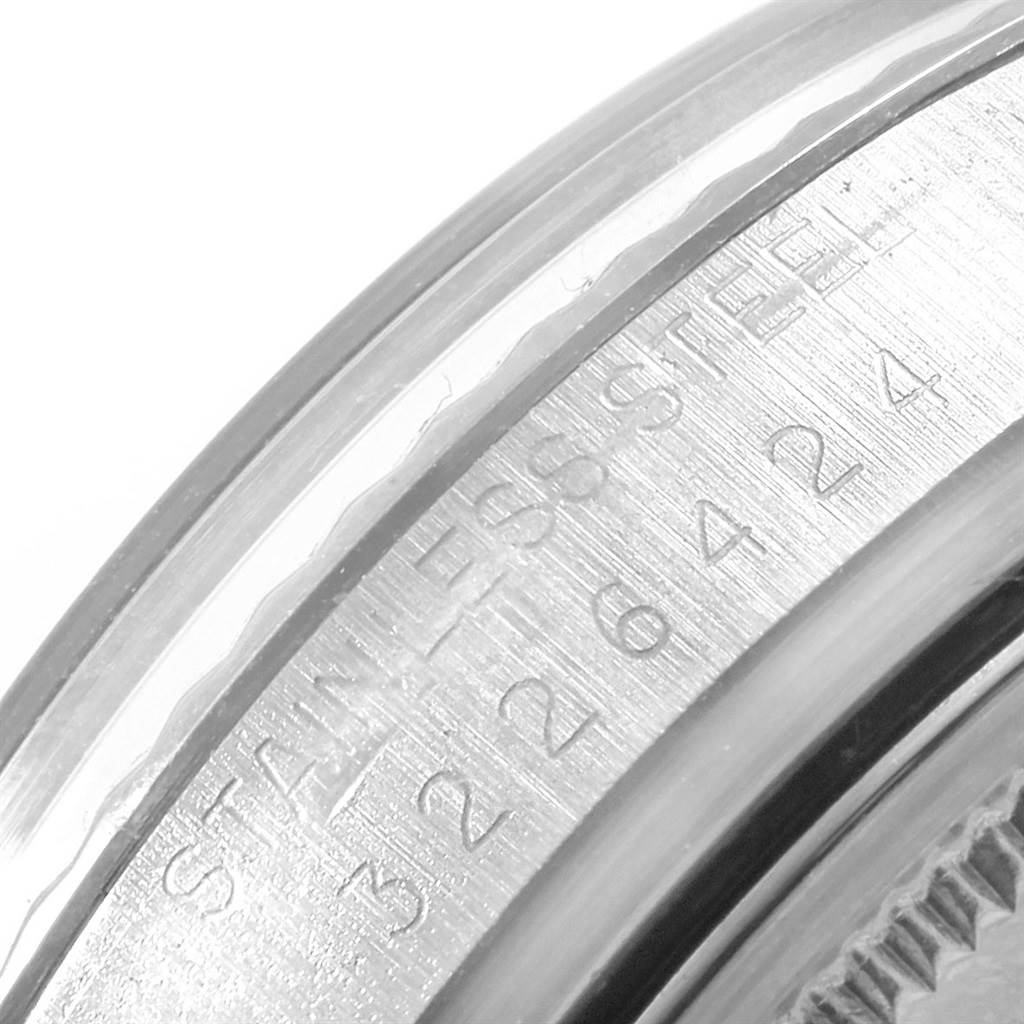 This image shows a close-up of the stainless steel bezel and part of the serial number of the Rolex Vintage Collection 1601 Men's Stainless Steel Silver Dial 1601 Men's Stainless Steel Silver Dial model.