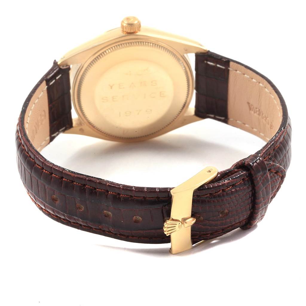 The image shows the back case and leather strap of a Rolex Vintage Collection 1002 Men's Yellow Gold Silver Dial 1002 Men's Yellow Gold Silver Dial model watch, highlighting the engraved back and clasp.