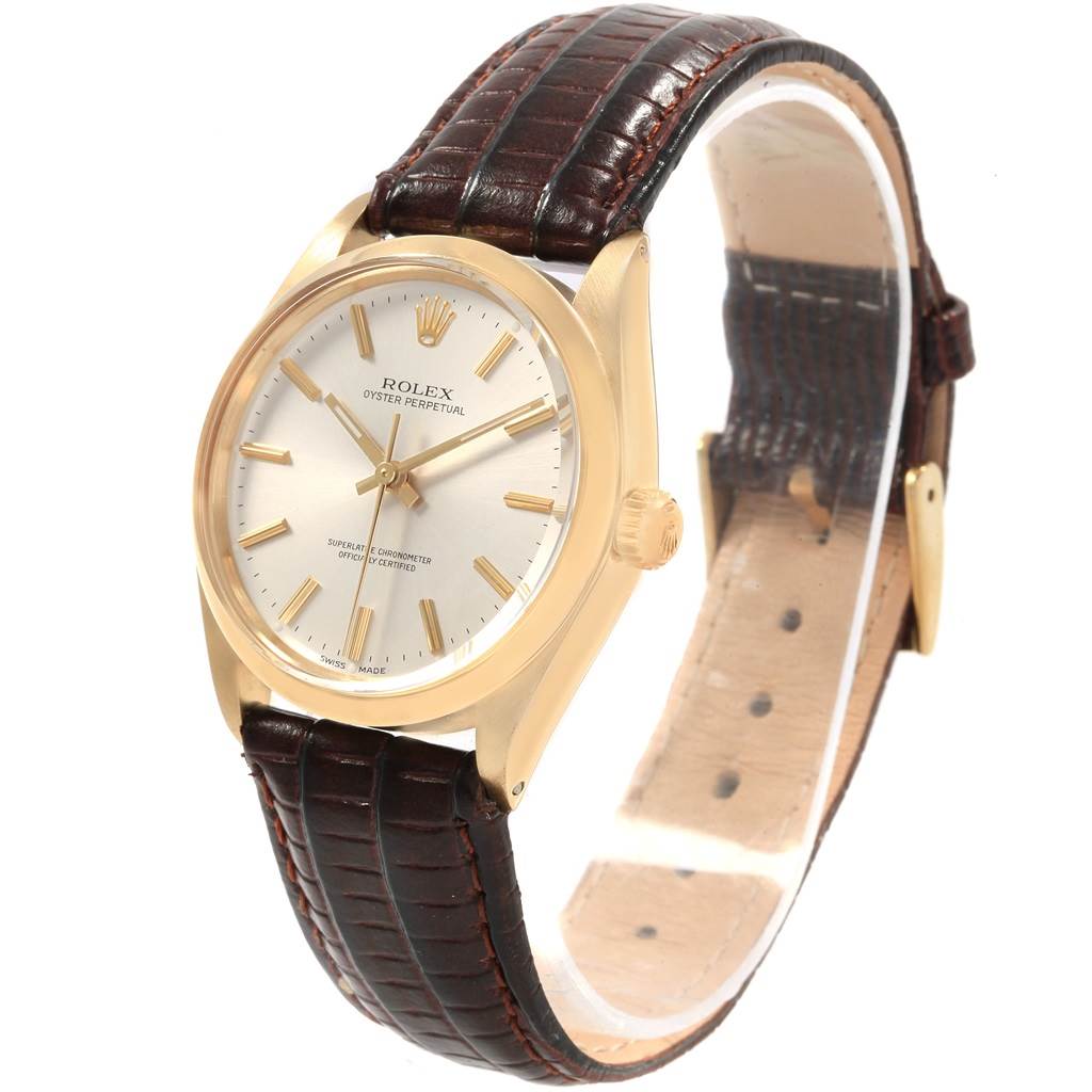The Rolex Vintage Collection 1002 Men's Yellow Gold Silver Dial 1002 Men's Yellow Gold Silver Dial model is shown from a three-quarter angle, highlighting its face, crown, and brown leather strap.