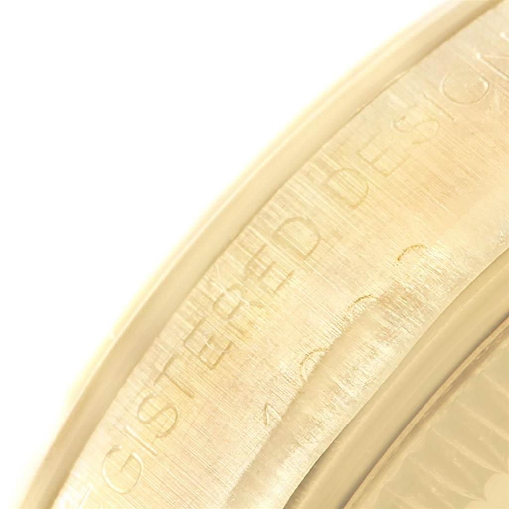 This is a close-up angle showing the engraved outer edge of the Rolex Vintage Collection 1002 Men's Yellow Gold Silver Dial 1002 Men's Yellow Gold Silver Dial watch.