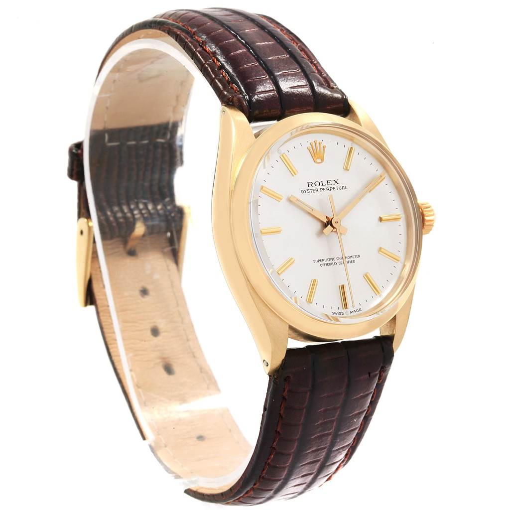 This image shows a side view of the Rolex Vintage Collection 1002 Men's Yellow Gold Silver Dial 1002 Men's Yellow Gold Silver Dial watch, highlighting its gold case, white dial, and brown leather strap.