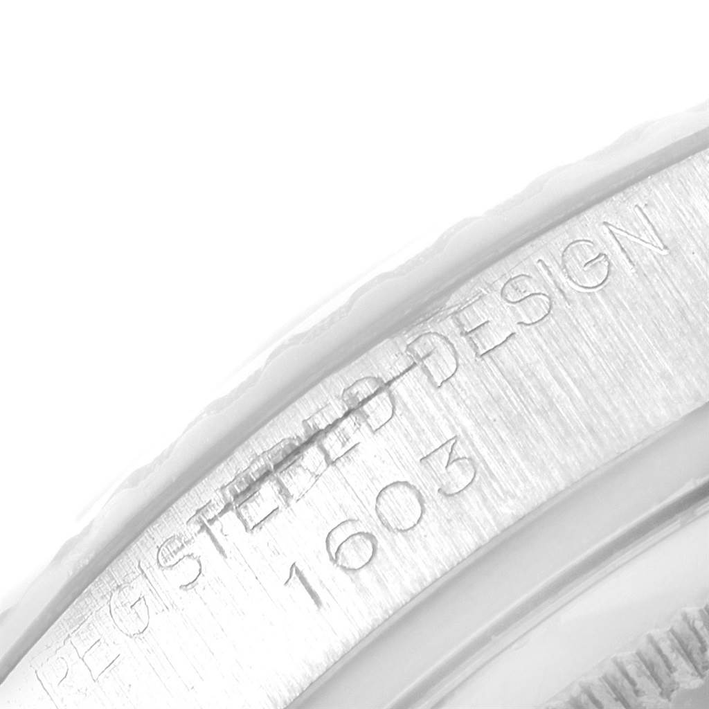 This image shows an extreme close-up of the case back and edge of the Rolex Vintage Collection 1603 Men
s Stainless Steel Silver Dial 1603 Men
s Stainless Steel Silver Dial model watch with the engraving "REGISTERED DESIGN 1603."