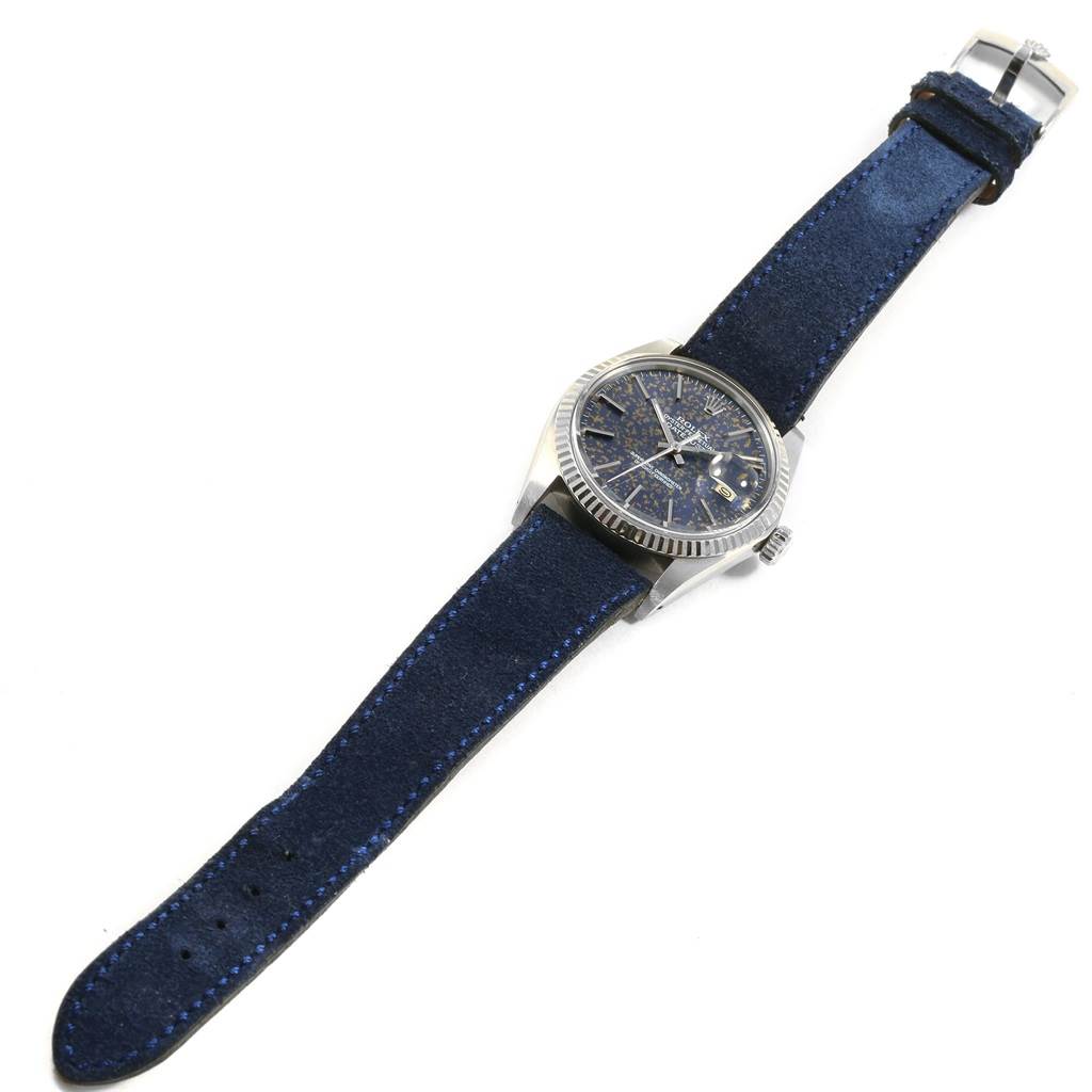 This image shows a Rolex Vintage Collection 16014 Men
s Stainless Steel Blue Dial 16014 Men
s Stainless Steel Blue Dial watch with a blue suede strap and a textured blue dial, viewed from an angled top-down perspective.
