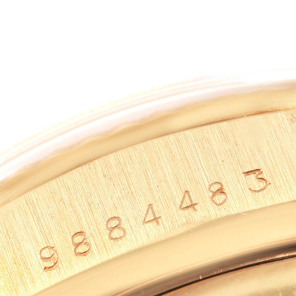 The image shows a close-up of the edge of a Rolex Vintage Collection 16018 Men
s Yellow Gold Black Dial 16018 Men
s Yellow Gold Black Dial watch, featuring part of its serial number.