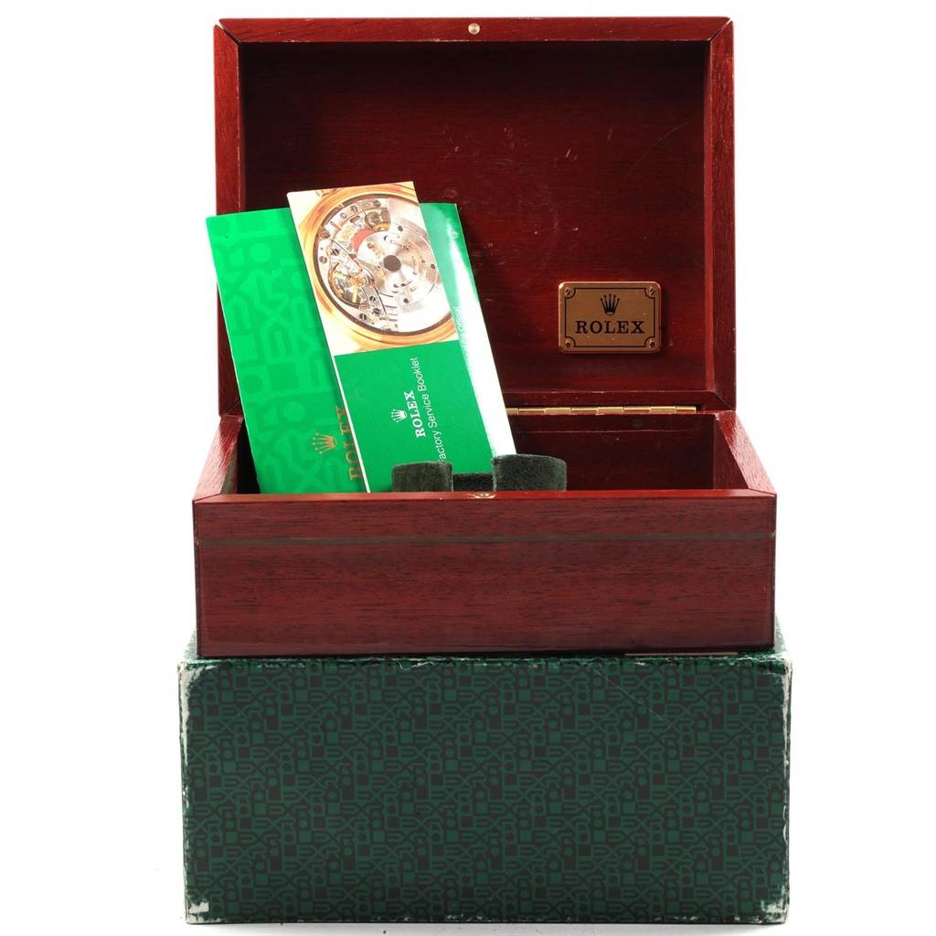 The image shows a wooden Rolex box for the Vintage Collection model, containing booklets, at a front angle view.