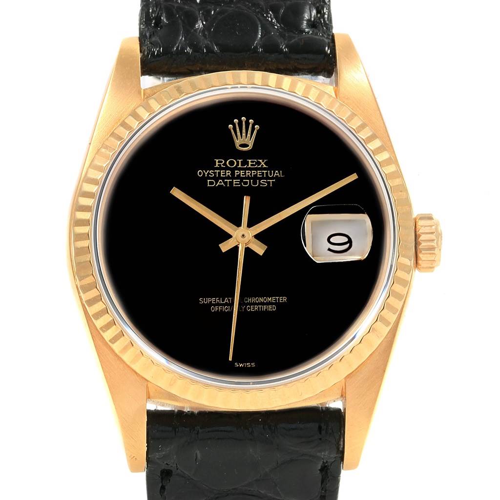 The image shows a Rolex Vintage Collection 16018 Men
s Yellow Gold Black Dial 16018 Men
s Yellow Gold Black Dial Datejust watch with a black dial, gold fluted bezel, and black leather strap, viewed from the front.