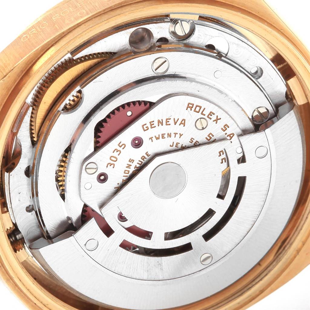 The image shows the internal mechanical movement of a Rolex Vintage Collection 16018 Men
s Yellow Gold Black Dial 16018 Men
s Yellow Gold Black Dial model, featuring gears and a rotor, viewed from the back.