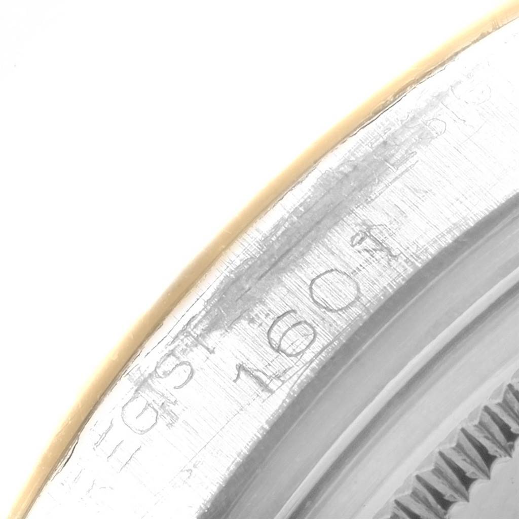 This close-up image shows the engraved serial number on the bezel edge of a Rolex Vintage Collection 1601 Men
s Steel and Gold (two tone) Champagne Dial 1601 Men
s Steel and Gold (two tone) Champagne Dial model watch.