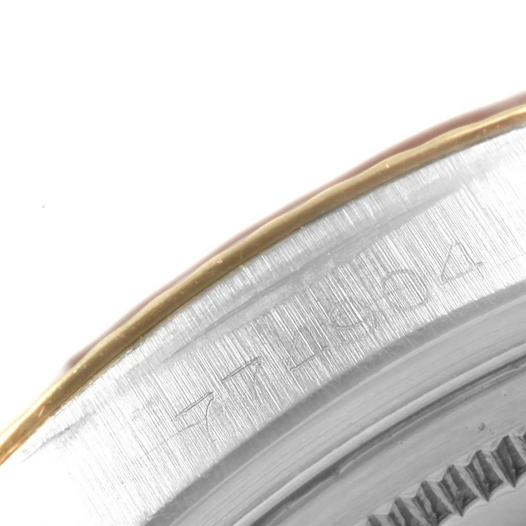 The image shows a close-up of the outer bezel and case of a Rolex Vintage Collection 1601 Men
s Steel and Gold (two tone) Champagne Dial 1601 Men
s Steel and Gold (two tone) Champagne Dial model.