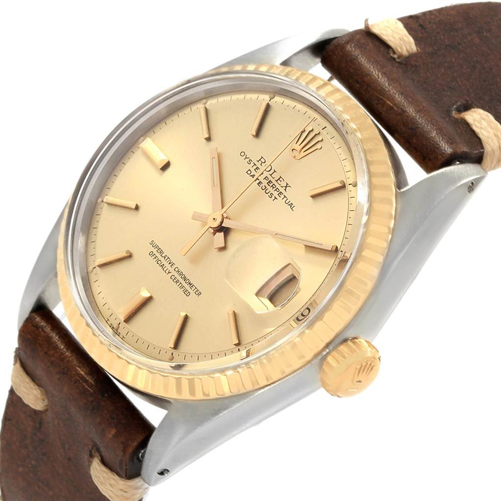 The image shows a close-up, angled view of the Rolex Vintage Collection 1601 Men
s Steel and Gold (two tone) Champagne Dial 1601 Men
s Steel and Gold (two tone) Champagne Dial watch, highlighting its dial, bezel, crown, and leather strap.