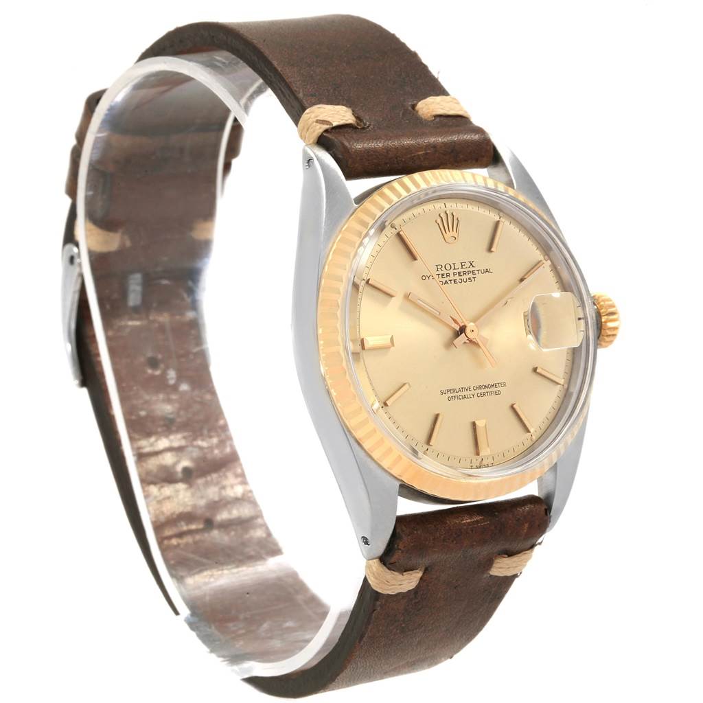 This image shows a Rolex Vintage Collection 1601 Men
s Steel and Gold (two tone) Champagne Dial 1601 Men
s Steel and Gold (two tone) Champagne Dial watch featuring its face, bezel, case, crown, and leather strap, angled slightly side-on.