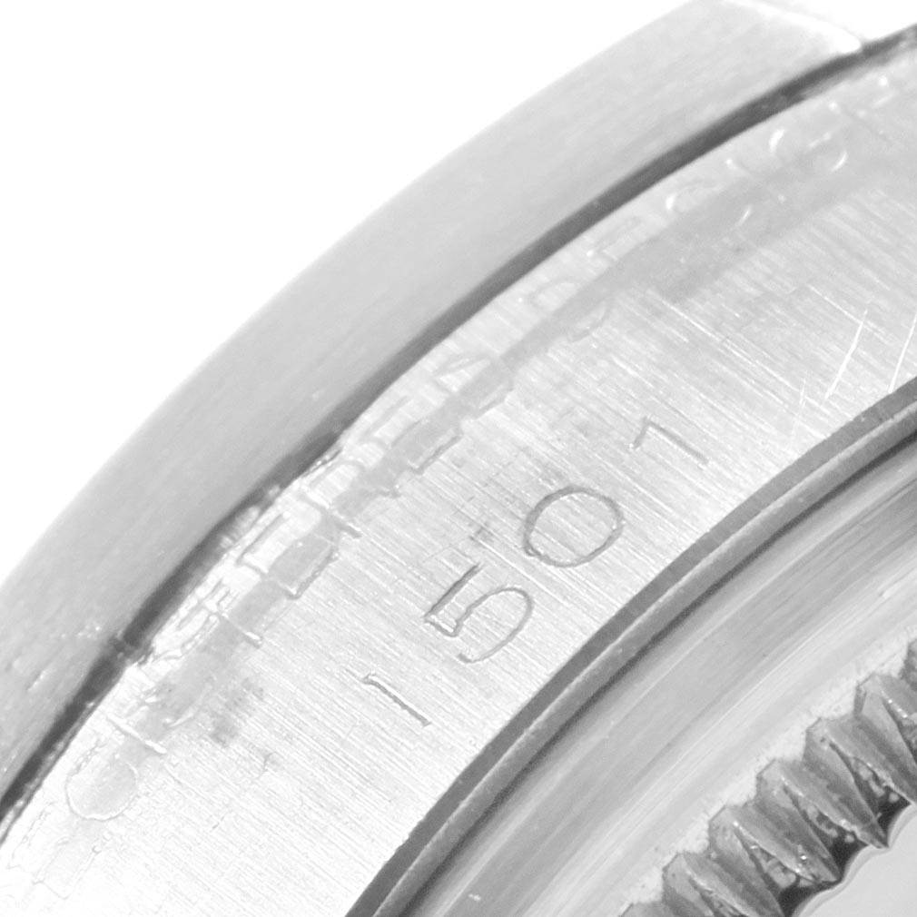 The image shows a close-up of the bezel and part of the case of a Rolex Vintage Collection 1501 Men
s Stainless Steel Silver Dial 1501 Men
s Stainless Steel Silver Dial model watch.