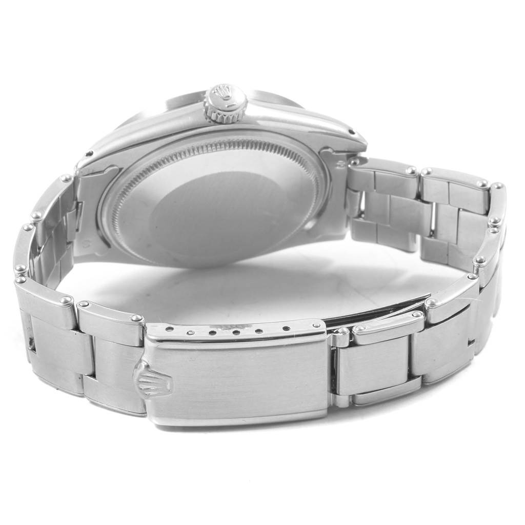 The image shows the back view of a Rolex Vintage Collection 1501 Men
s Stainless Steel Silver Dial 1501 Men
s Stainless Steel Silver Dial watch, including the case back, crown, and bracelet.