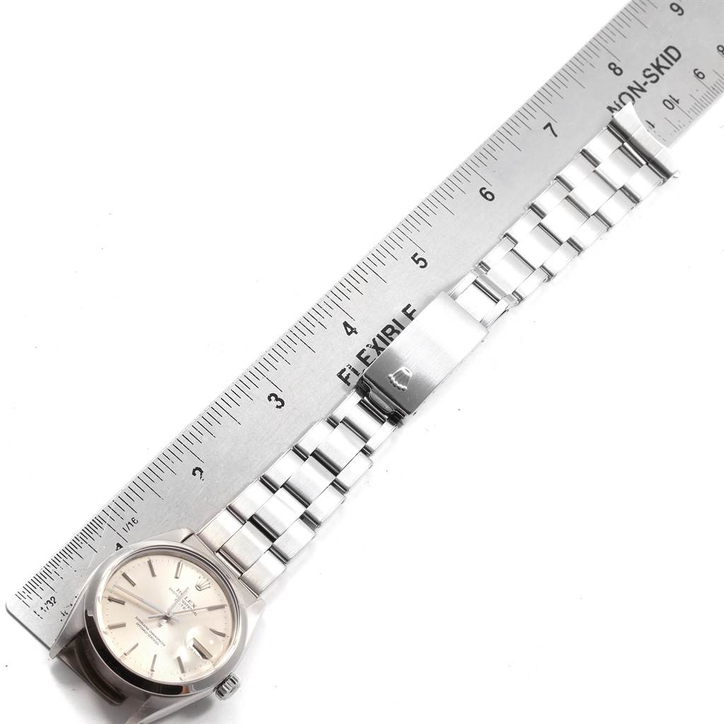 The watch, a Vintage Collection model by Rolex, is displayed with its face, bracelet, and clasp visible alongside a ruler for measurement.