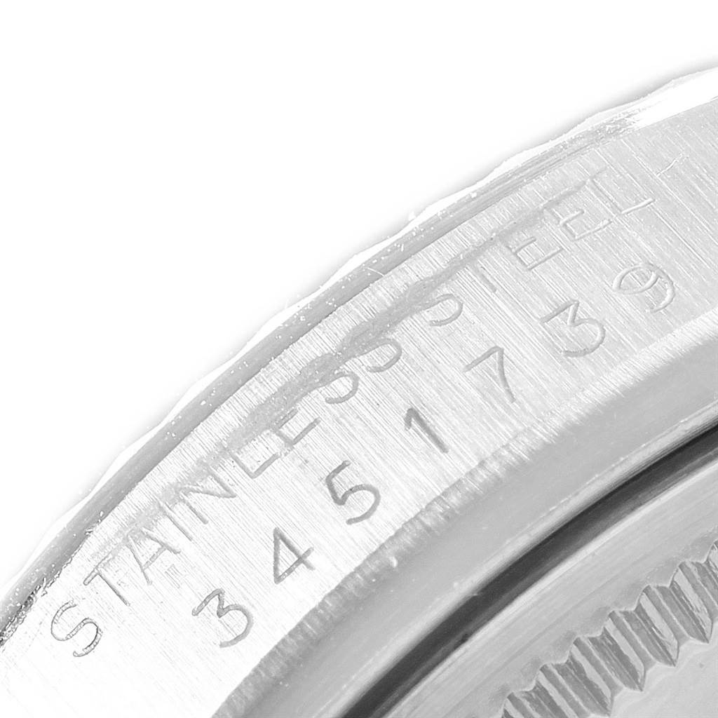 This close-up shows the side part of the bezel and case, displaying the engraving, on a Rolex Vintage Collection 1601 Men's Stainless Steel Silver Dial 1601 Men's Stainless Steel Silver Dial watch.