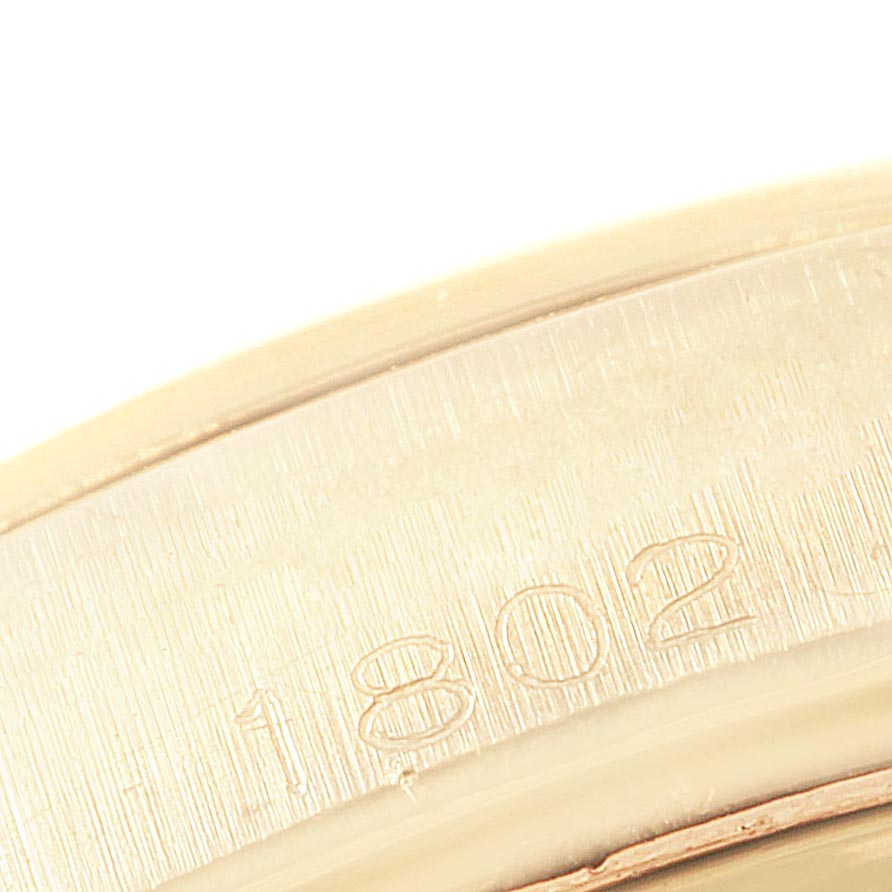 This close-up image shows the engraved serial or reference number "1802" on the casing of a Rolex Vintage Collection 1802 Men's Yellow Gold Champagne Dial 1802 Men's Yellow Gold Champagne Dial watch.