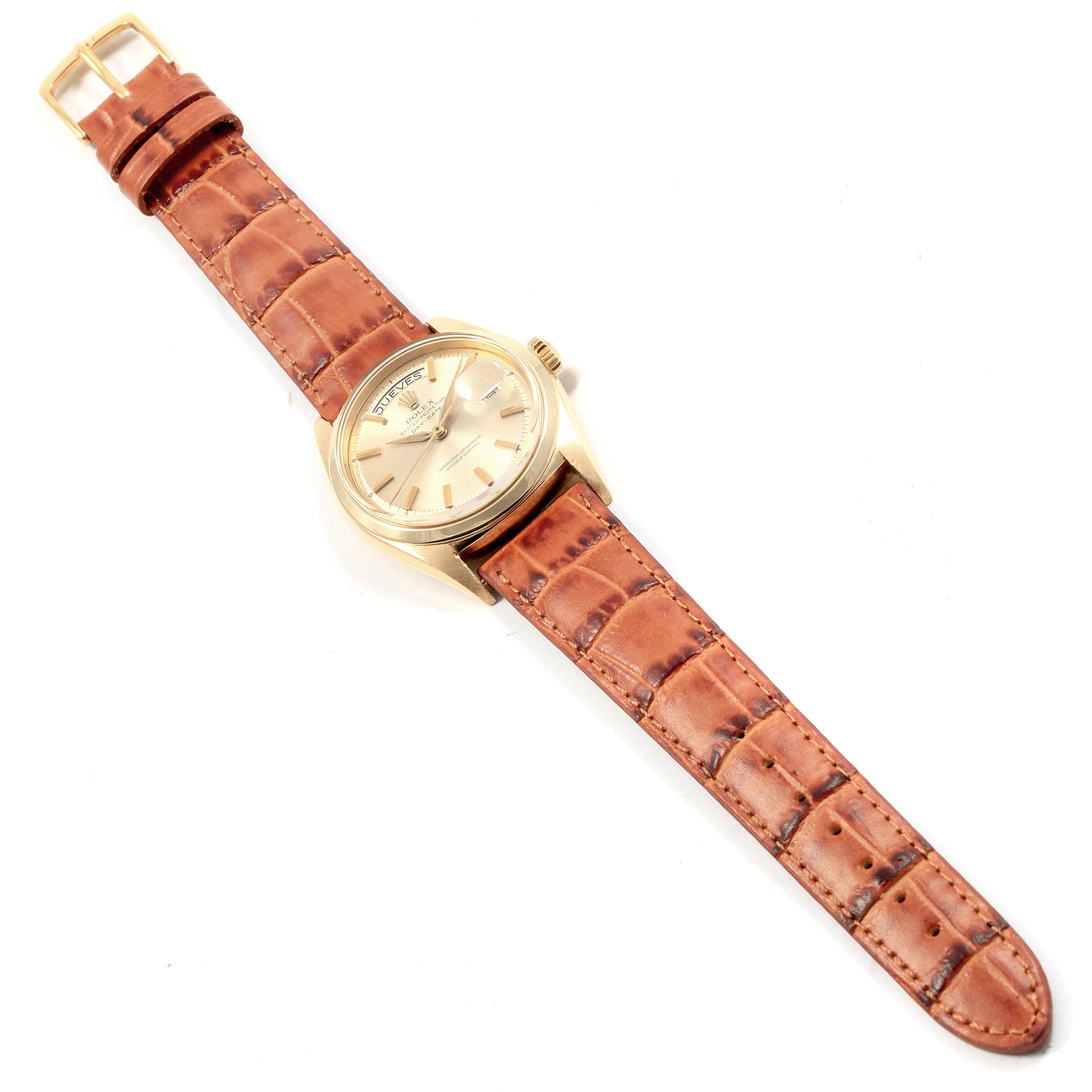 The Rolex Vintage Collection 1802 Men's Yellow Gold Champagne Dial 1802 Men's Yellow Gold Champagne Dial watch, shown from an overhead angle, features a brown leather strap and a gold case with a beige dial.