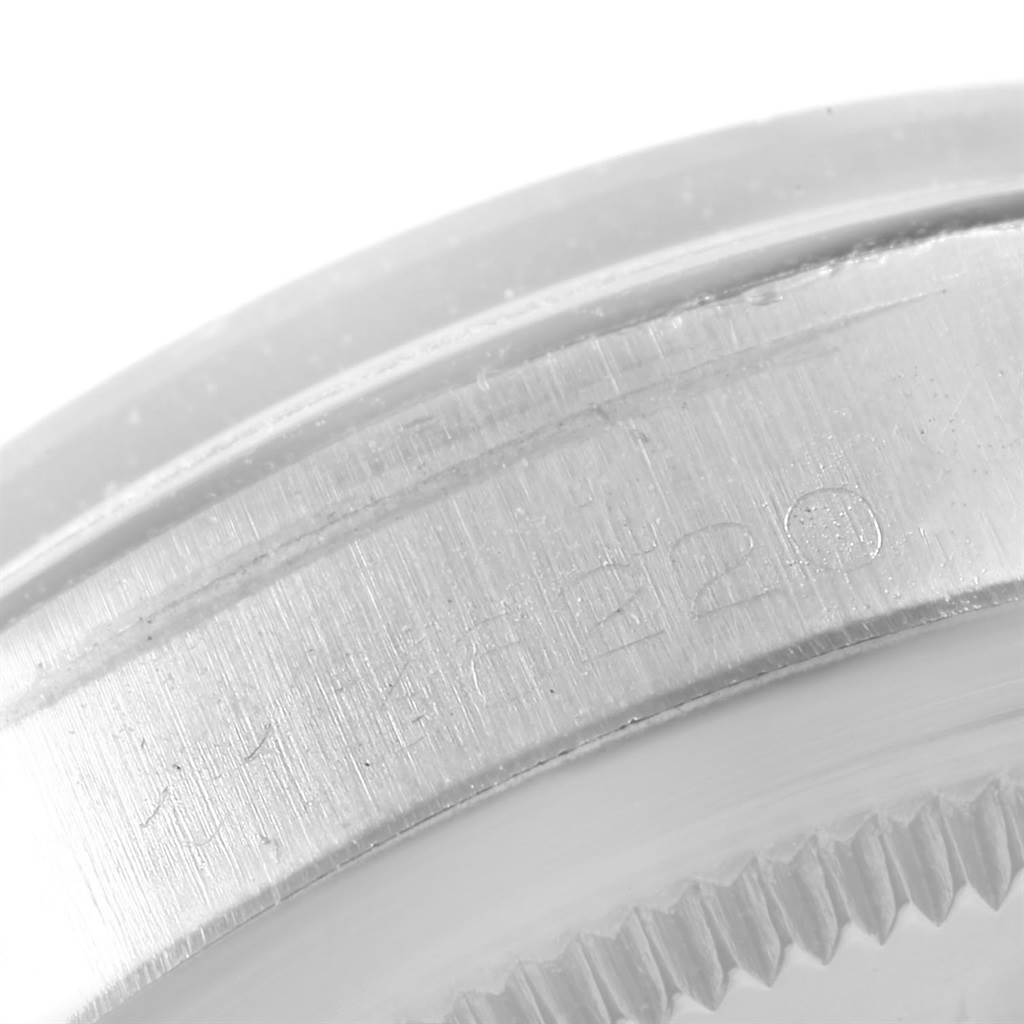 This image shows a close-up of the side of a Rolex Vintage Collection 1500 Men
s Stainless Steel Silver Dial 1500 Men
s Stainless Steel Silver Dial model, focusing on part of the bezel and the engraved markings.