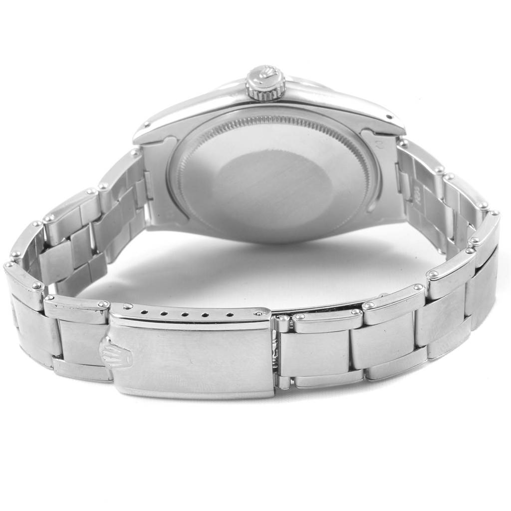 The image shows the back view of a Rolex Vintage Collection 1500 Men
s Stainless Steel Silver Dial 1500 Men
s Stainless Steel Silver Dial watch, highlighting the case back and metal bracelet.