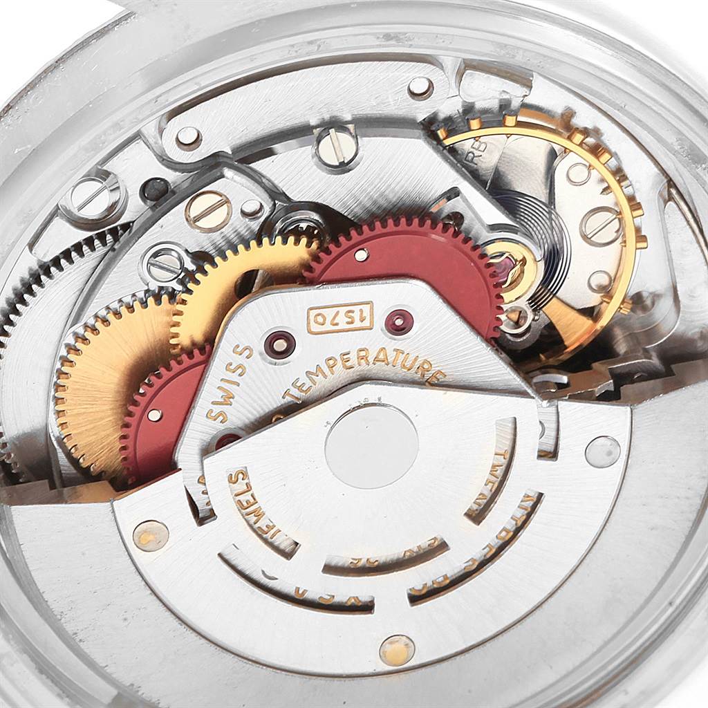 This image shows the intricate internal mechanics and gears of a Vintage Collection Rolex watch from an overhead angle.