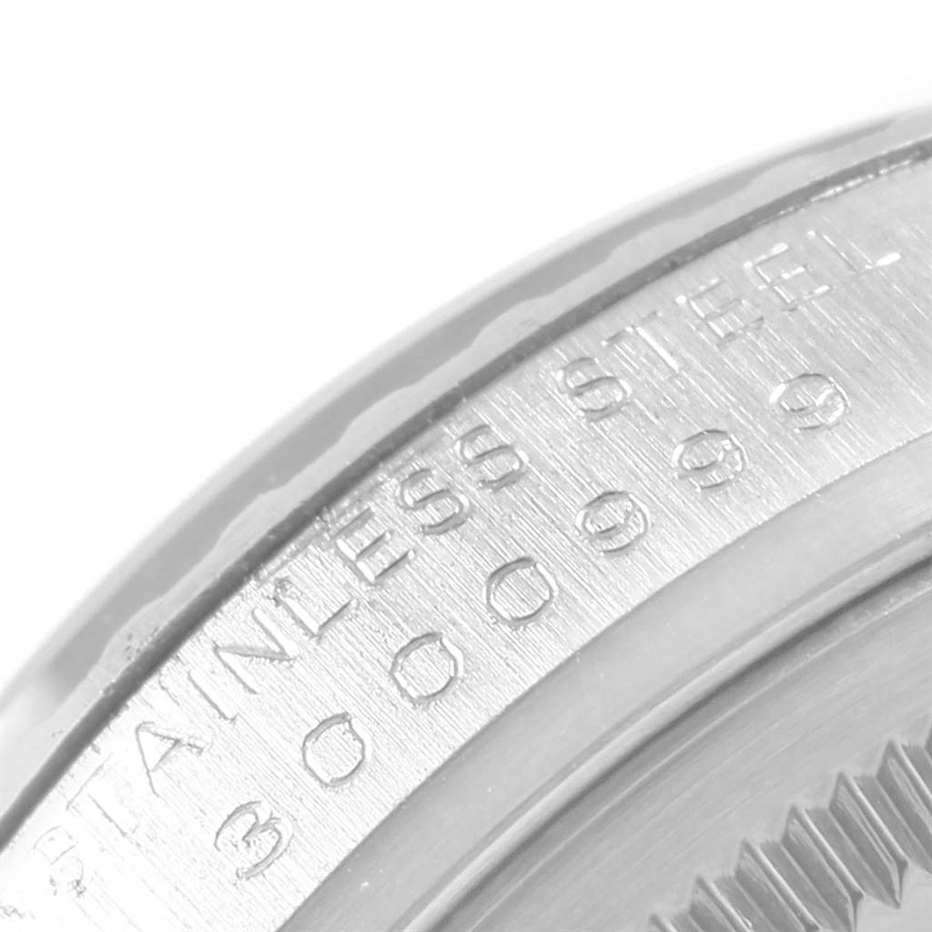 This image shows a close-up of the stainless steel casing with engraved numbers on the Vintage Collection model by Rolex.