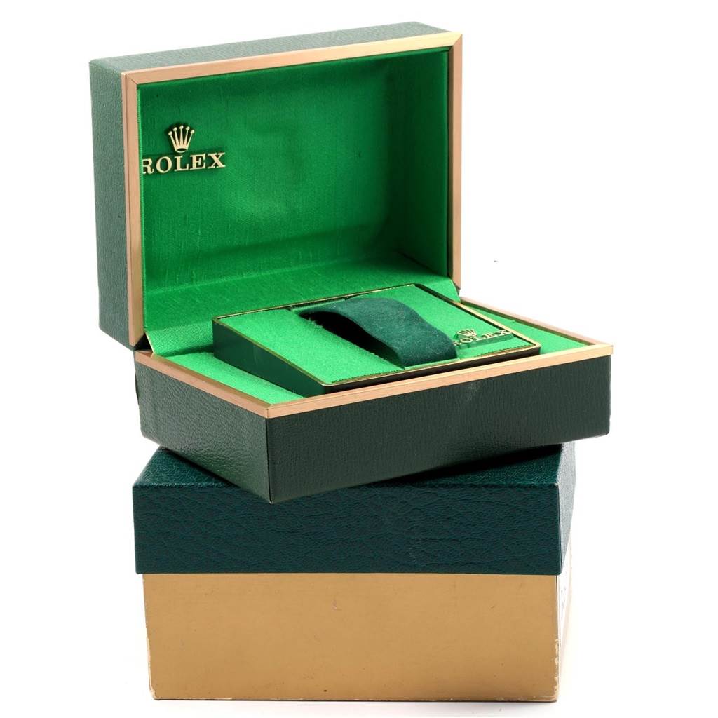 This image shows an opened green and gold box for the Rolex Vintage Collection 1603 Men
s Stainless Steel Grey Dial 1603 Men
s Stainless Steel Grey Dial watch, featuring the interior and logo.