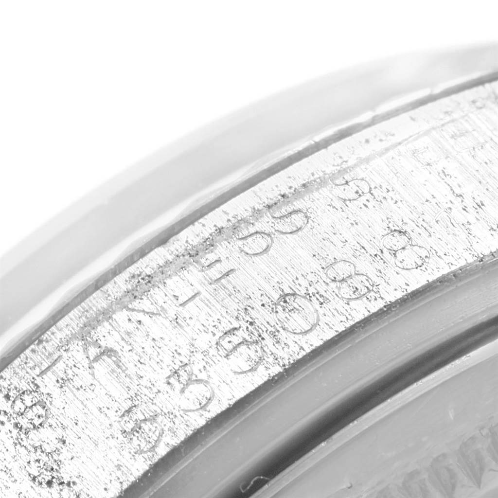 The image shows a close-up of the engraved case back of a Vintage Collection model by Rolex.