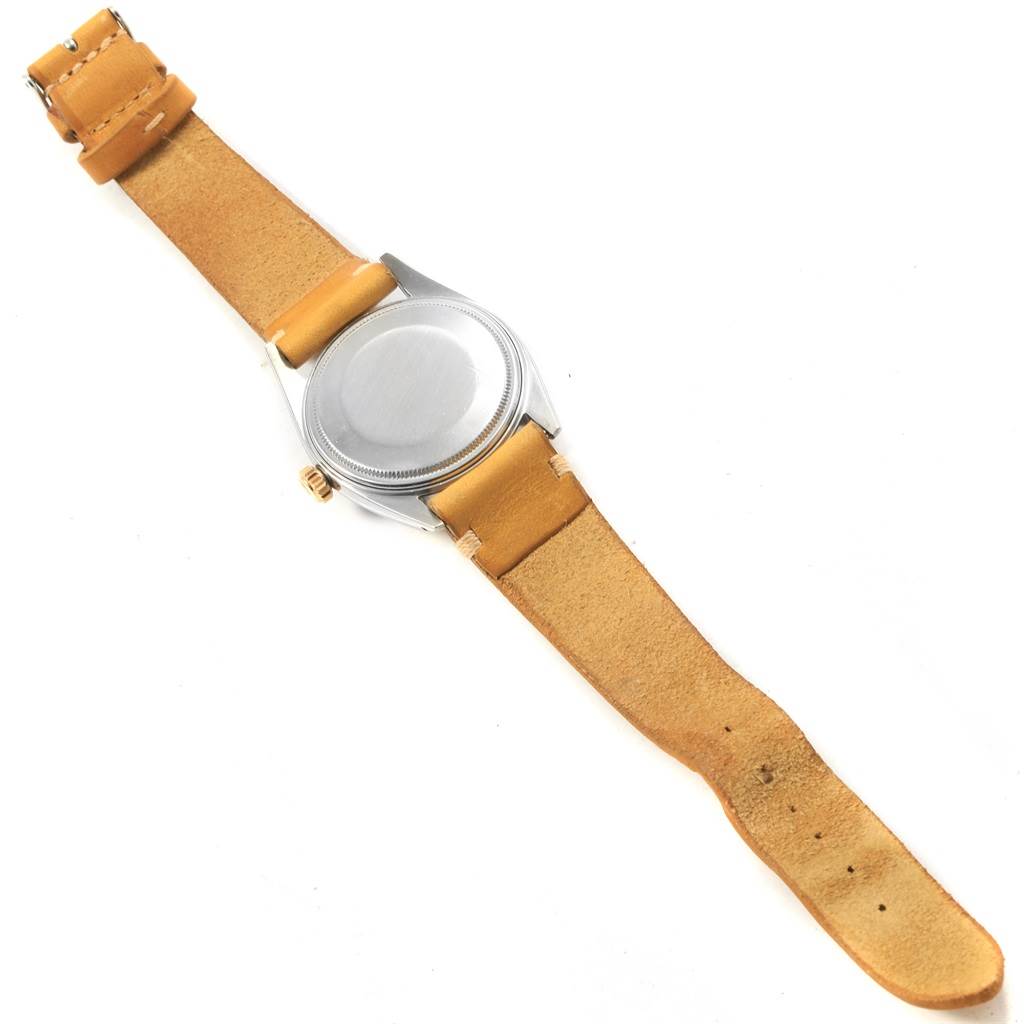 The image shows the back side of a Vintage Collection Rolex watch, highlighting the watch case and beige leather strap.