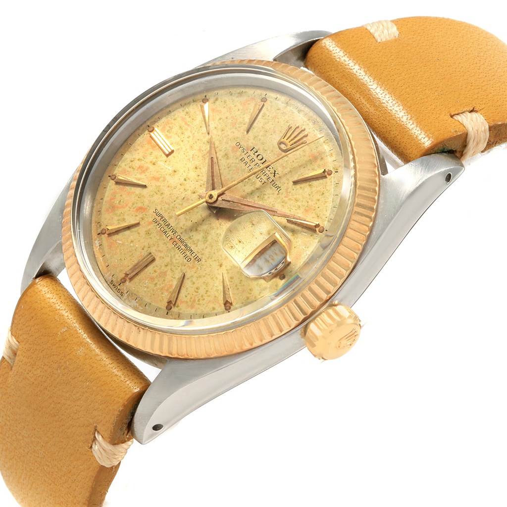 The Rolex Vintage Collection 1601 Men's Steel and Gold (two tone) Champagne Dial 1601 Men's Steel and Gold (two tone) Champagne Dial model watch is shown at an angled close-up, highlighting the face, bezel, crown, and part of the leather strap.