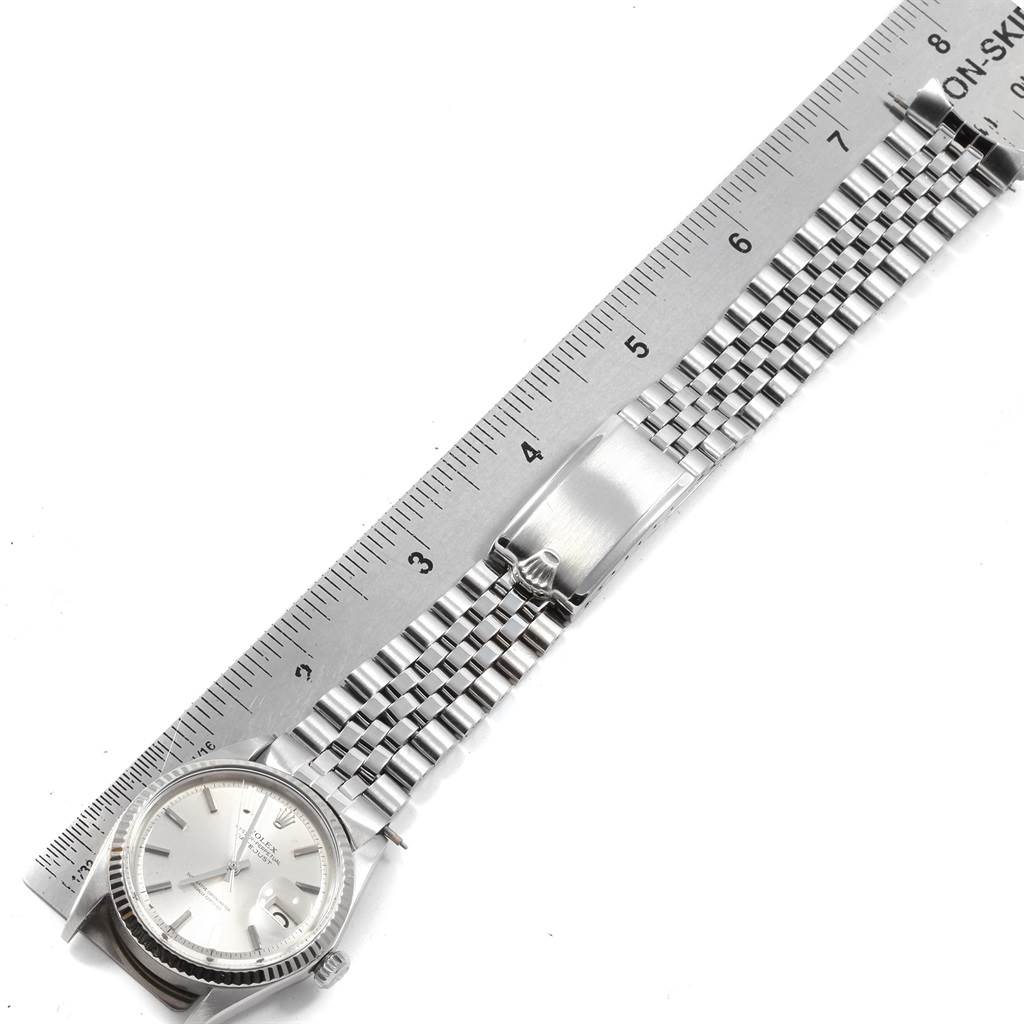 The image shows a Rolex Vintage Collection 1601 Men
s Stainless Steel Silver Dial 1601 Men
s Stainless Steel Silver Dial model watch laid flat with a ruler for scale, displaying the face, case, and bracelet.
