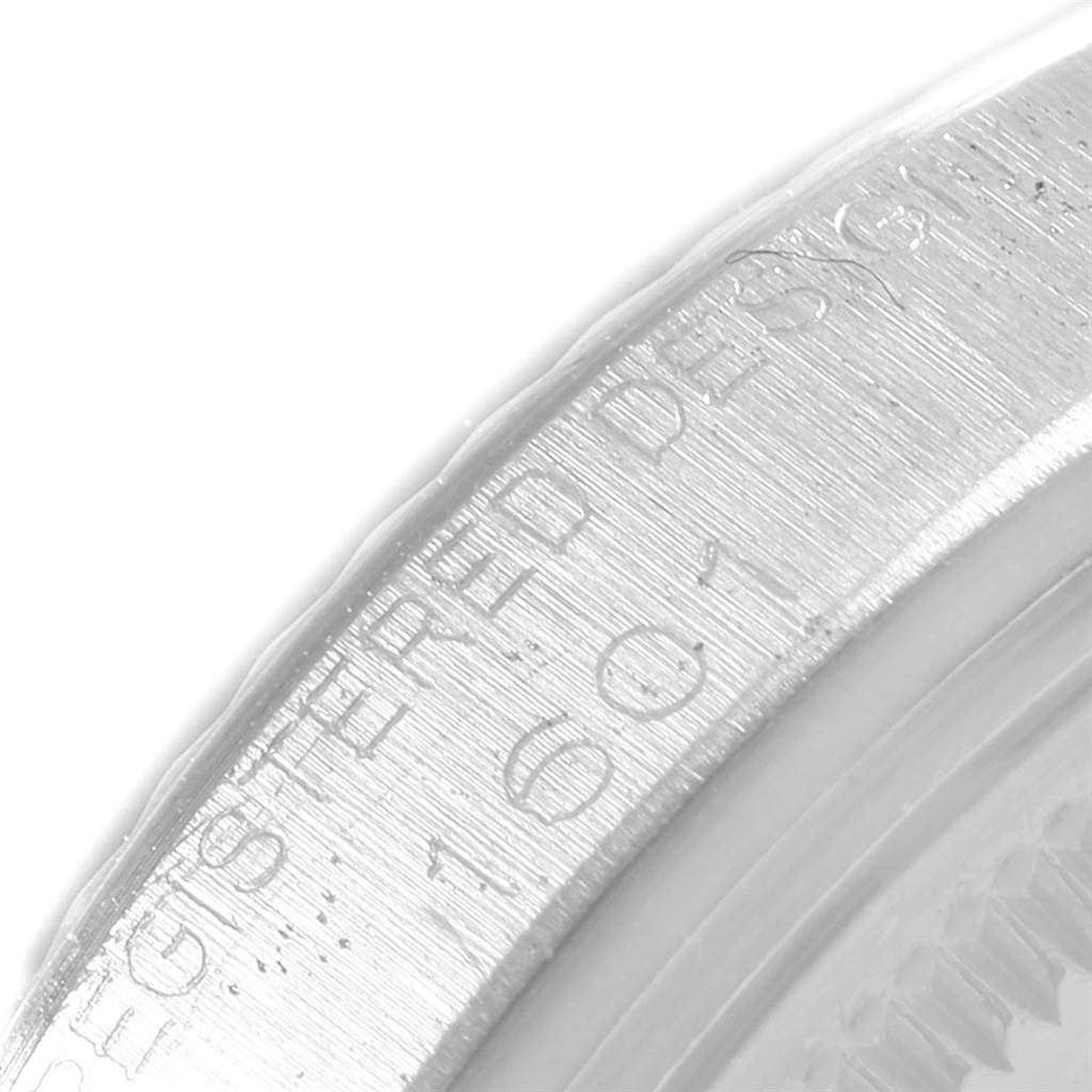 The image shows a close-up of the side case and bezel with engravings on a Rolex Vintage Collection 1601 Men
s Stainless Steel Silver Dial 1601 Men
s Stainless Steel Silver Dial watch.