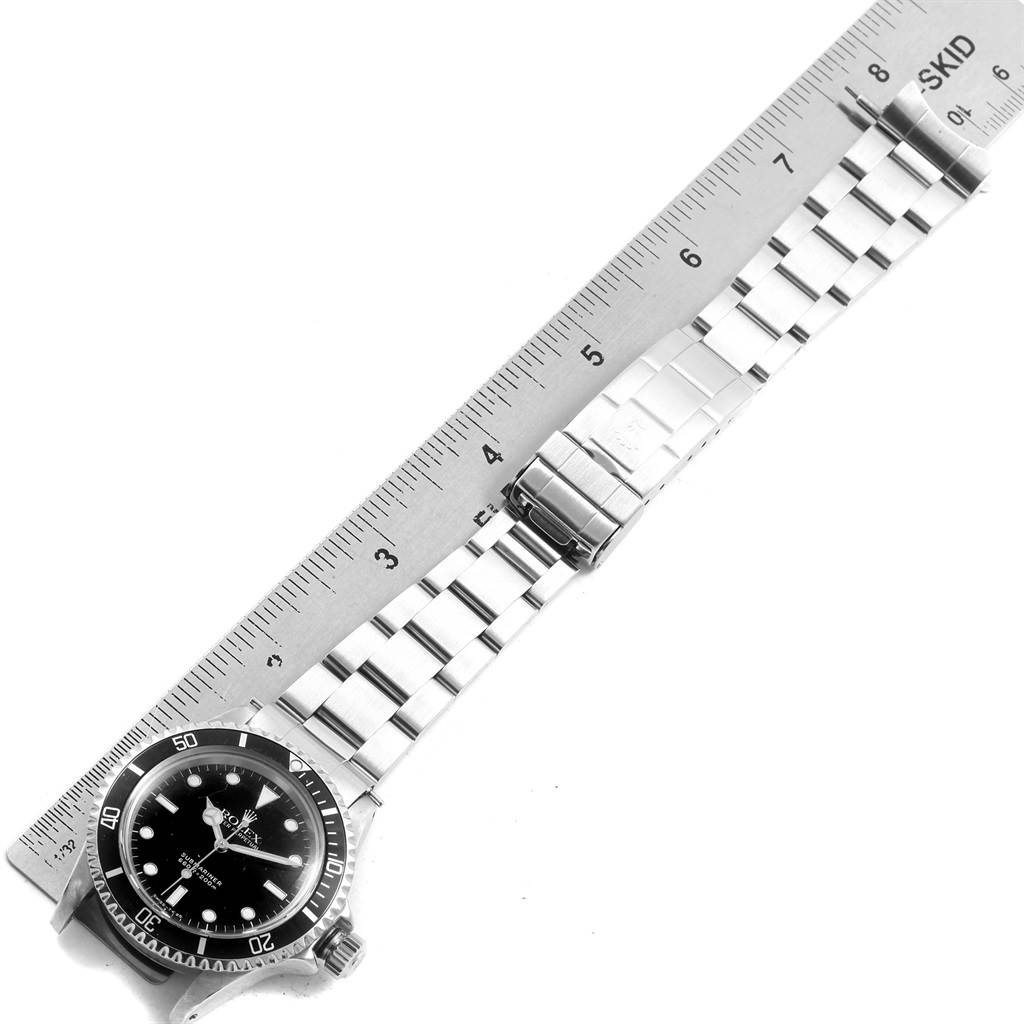 The image shows a Vintage Collection Rolex watch laid flat, with a ruler measuring the length of its metal bracelet.