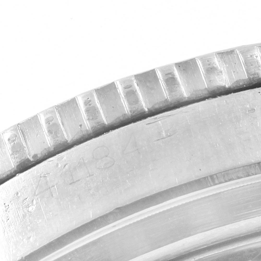 The image shows a close-up of the bezel and case side of a Vintage Collection Rolex watch, revealing intricate details and engravings.