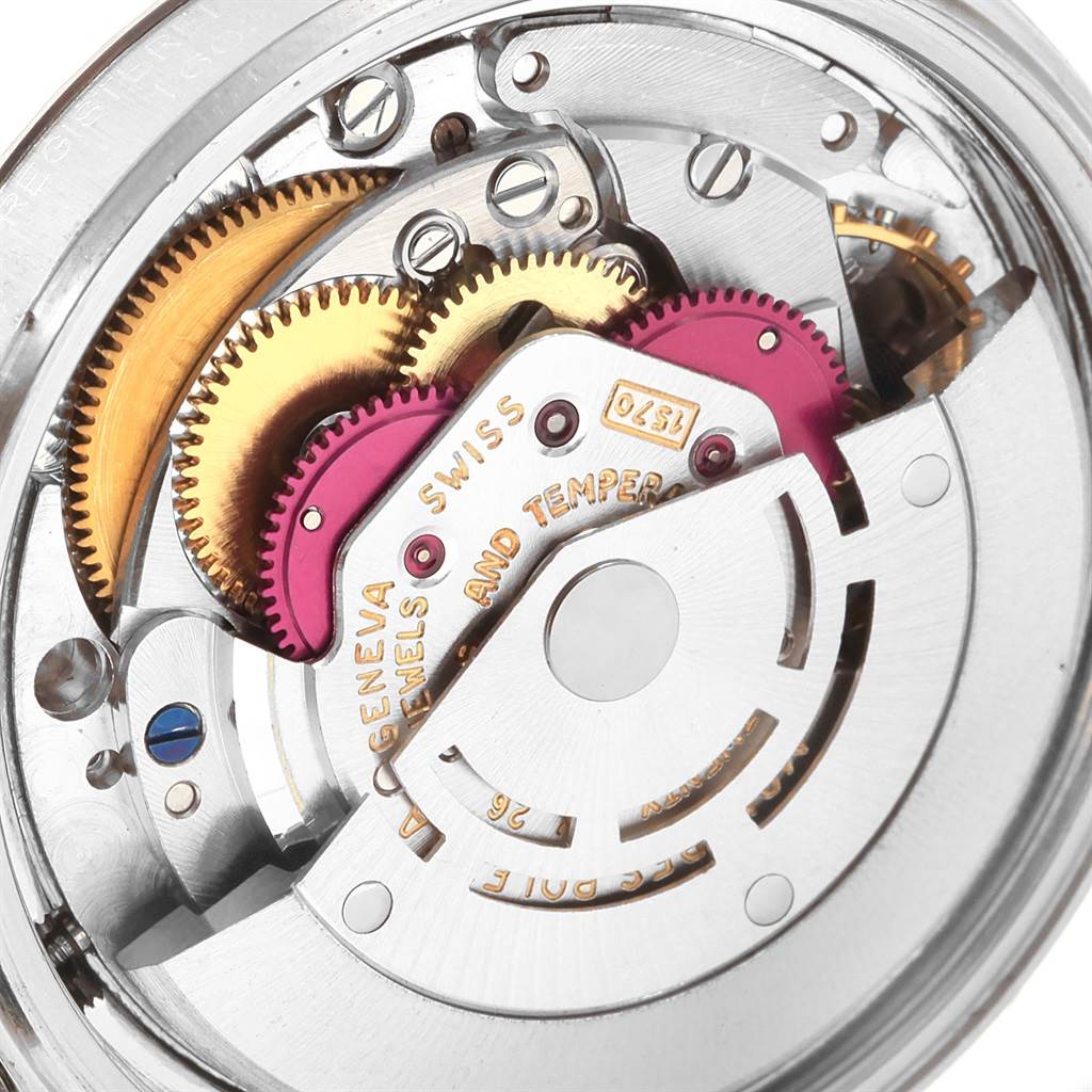 The image shows a close-up of the intricate inner mechanical components of a Vintage Collection Rolex watch.