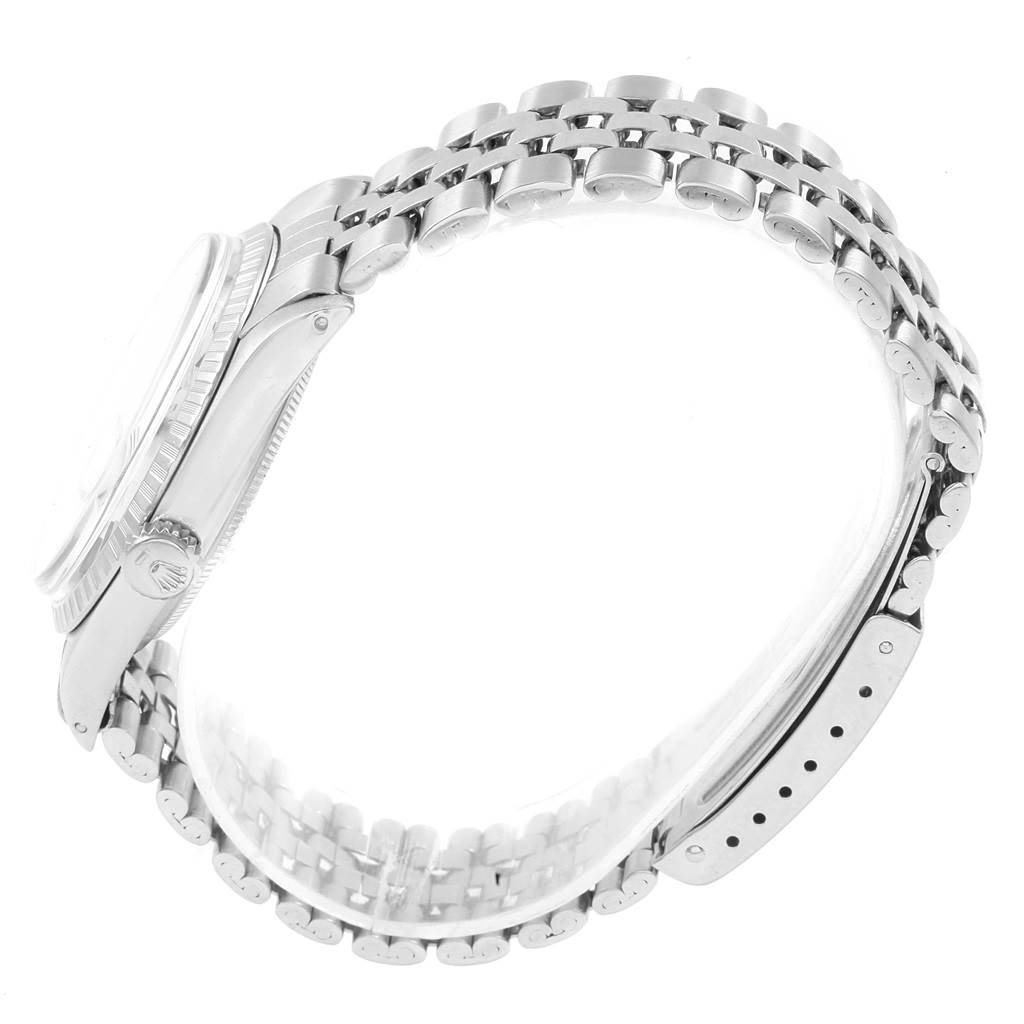 This side-angle view of the Rolex Vintage Collection 1603 Men
s Stainless Steel Silver Dial 1603 Men
s Stainless Steel Silver Dial watch highlights its linked bracelet and mid-case with the crown.