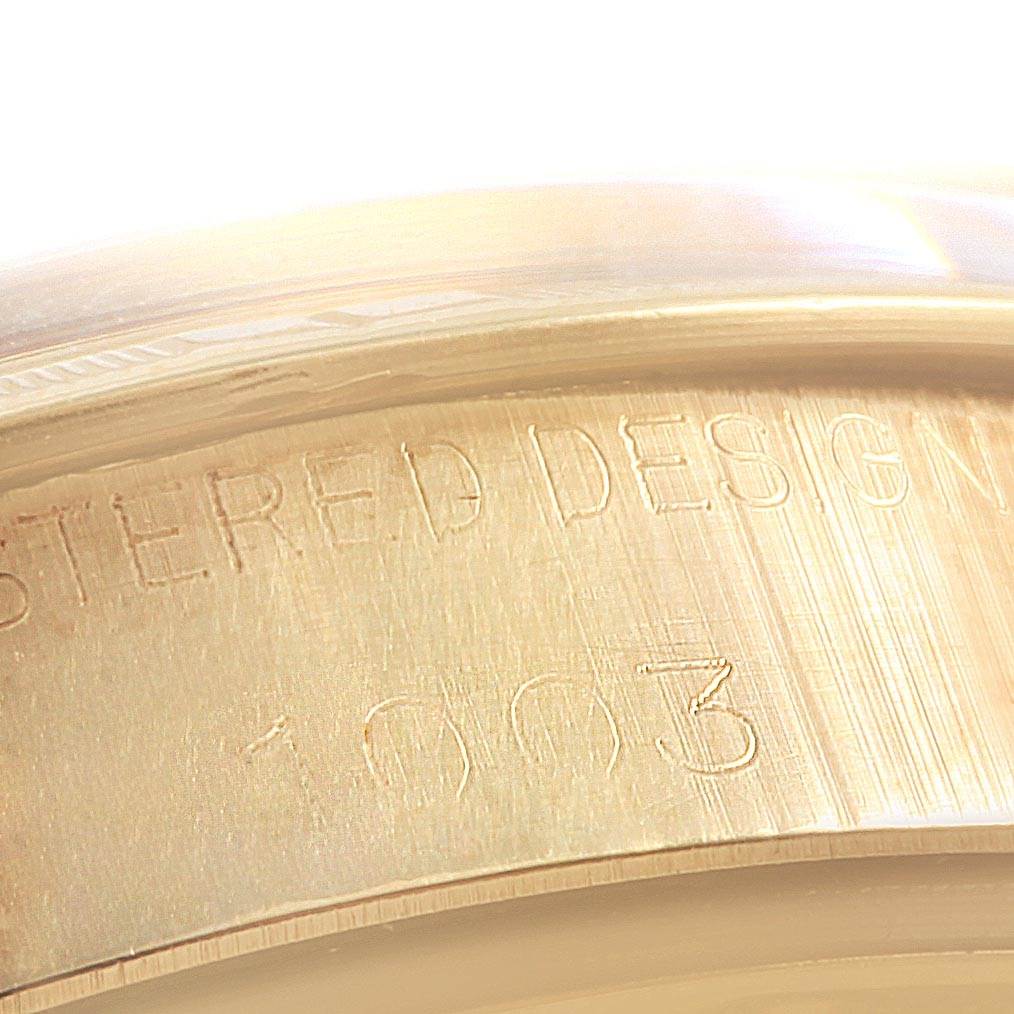 The image shows a close-up of the inner bezel of a Rolex Vintage Collection 1003 Men's Yellow Gold Silver Dial 1003 Men's Yellow Gold Silver Dial watch, highlighting the engraved text and numbers.