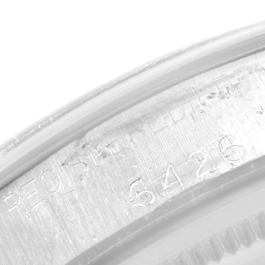 The image shows a close-up of the engraved serial number on the case side of a Rolex Vintage Collection 6426 Men's Stainless Steel Black Dial 6426 Men's Stainless Steel Black Dial watch.