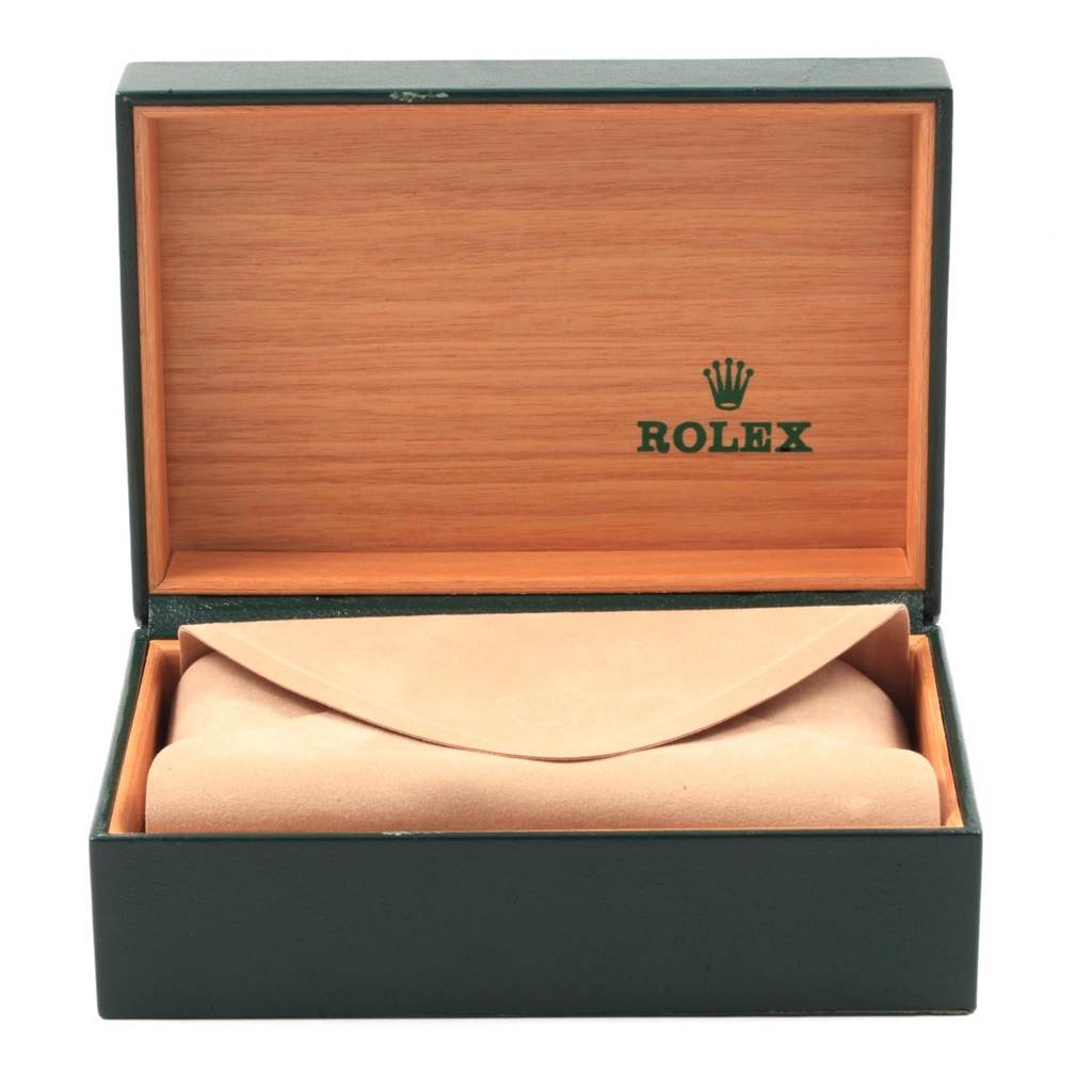 This image shows an open Rolex watch box containing the Vintage Collection model, with the watch hidden inside a beige pouch.