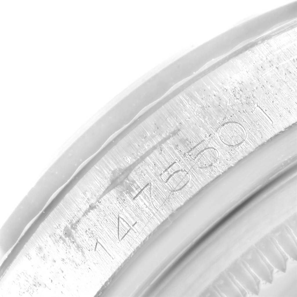 This close-up image shows the serial number engraved on the side of a Rolex Vintage Collection 1601 Men's Stainless Steel Silver Dial 1601 Men's Stainless Steel Silver Dial watch case.