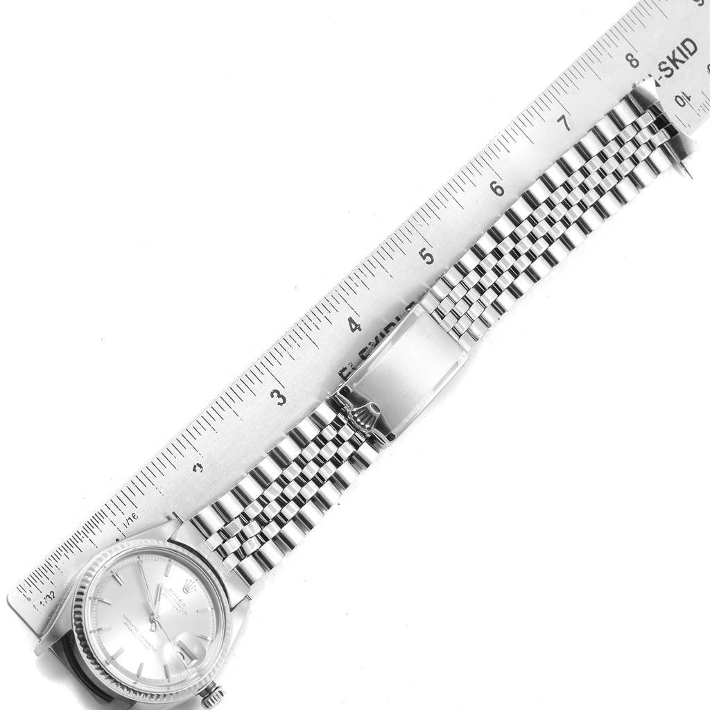 The Vintage Collection Rolex watch is shown from an angled top view, including the face, bracelet, and clasp alongside a ruler.