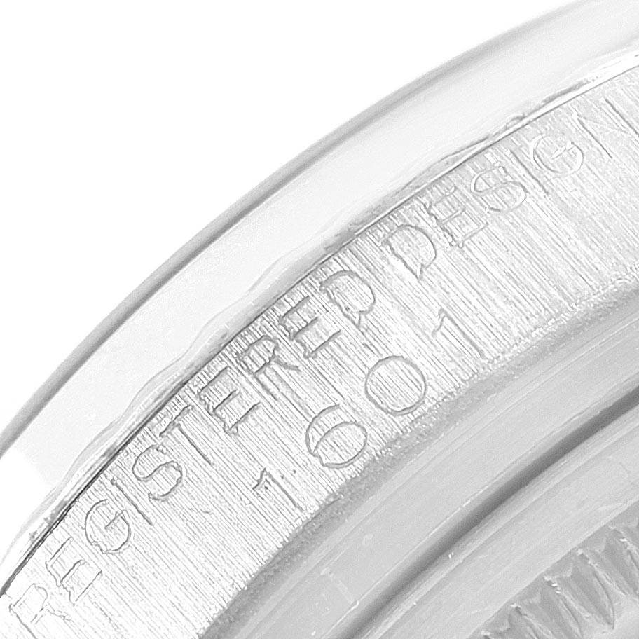 The image shows a close-up of the engraved text on the side of the Rolex Vintage Collection 1601 Men's Stainless Steel Silver Dial 1601 Men's Stainless Steel Silver Dial watch case.