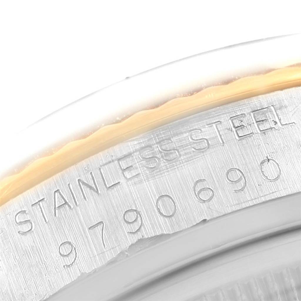 This close-up shot shows the engraved stainless steel case back of the Vintage Collection Rolex watch.