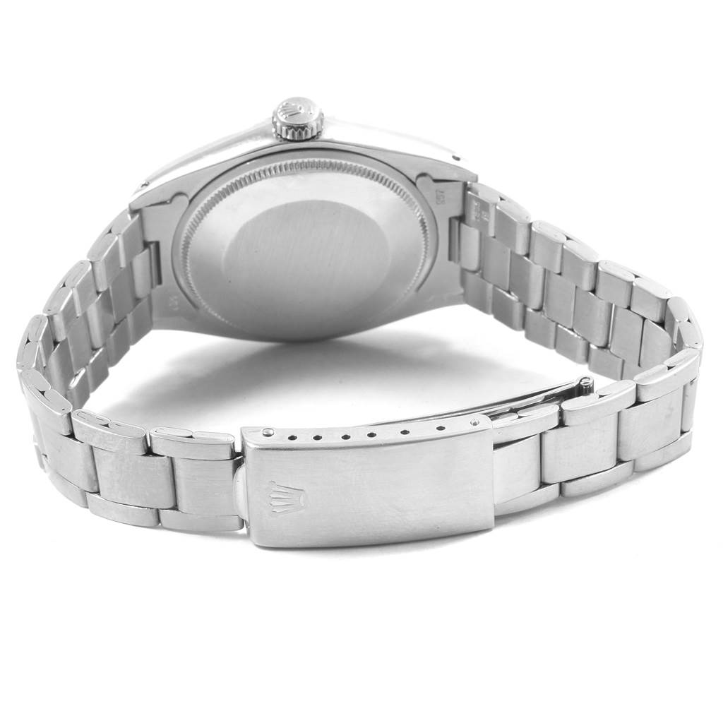 The image shows the back view of a Vintage Collection Rolex watch, highlighting the bracelet, clasp, case back, and crown.