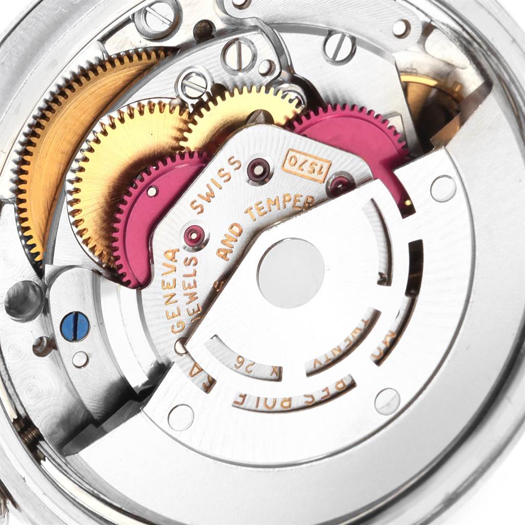 The image shows the internal mechanism and gears of a Vintage Collection Rolex watch from a close-up angle.