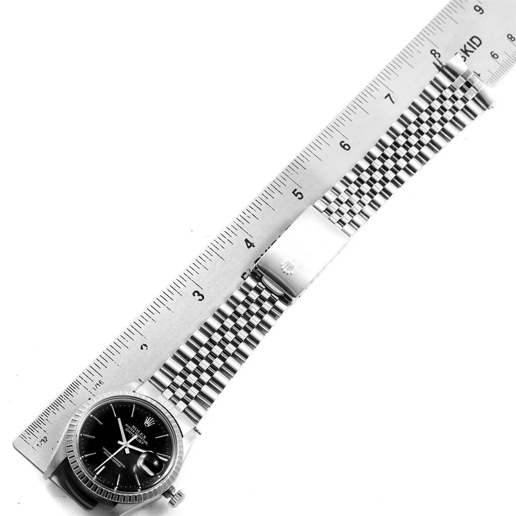 The image shows the Rolex Vintage Collection 16030 Men's Stainless Steel Black Dial 16030 Men's Stainless Steel Black Dial watch lying flat, highlighting the face, bracelet, and clasp along with a ruler for scale.