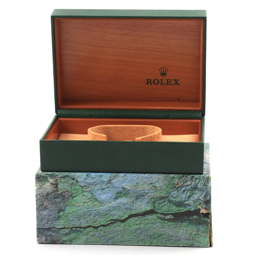 The image shows an open green and wood Rolex box with a watch cushion inside for the Vintage Collection model.