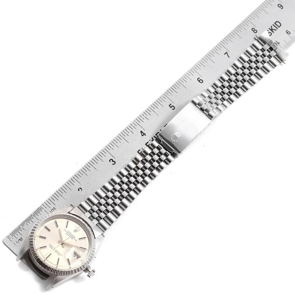 The image shows a flat-lay view of a Rolex Vintage Collection 1603 Men's Stainless Steel Silver Dial 1603 Men's Stainless Steel Silver Dial watch with a ruler measuring its length.