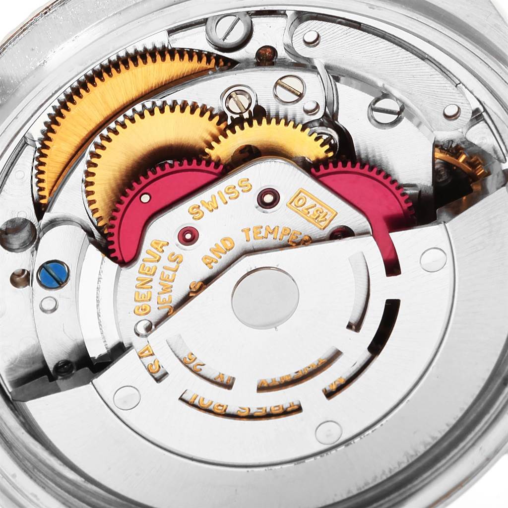 The image shows a close-up of the internal mechanism of a Vintage Collection model by Rolex, featuring gears and intricate components.