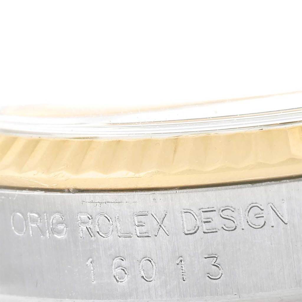 This image shows a close-up of the side of a Rolex Vintage Collection 16013 Men's Stainless Steel White Dial 16013 Men's Stainless Steel White Dial watch, highlighting its model number "16013" and "Orig Rolex Design" engraving.