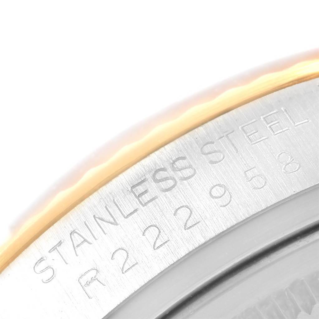 The image shows an extreme close-up of the engraved stainless steel edge of a Rolex Vintage Collection 16013 Men's Stainless Steel White Dial 16013 Men's Stainless Steel White Dial watch.